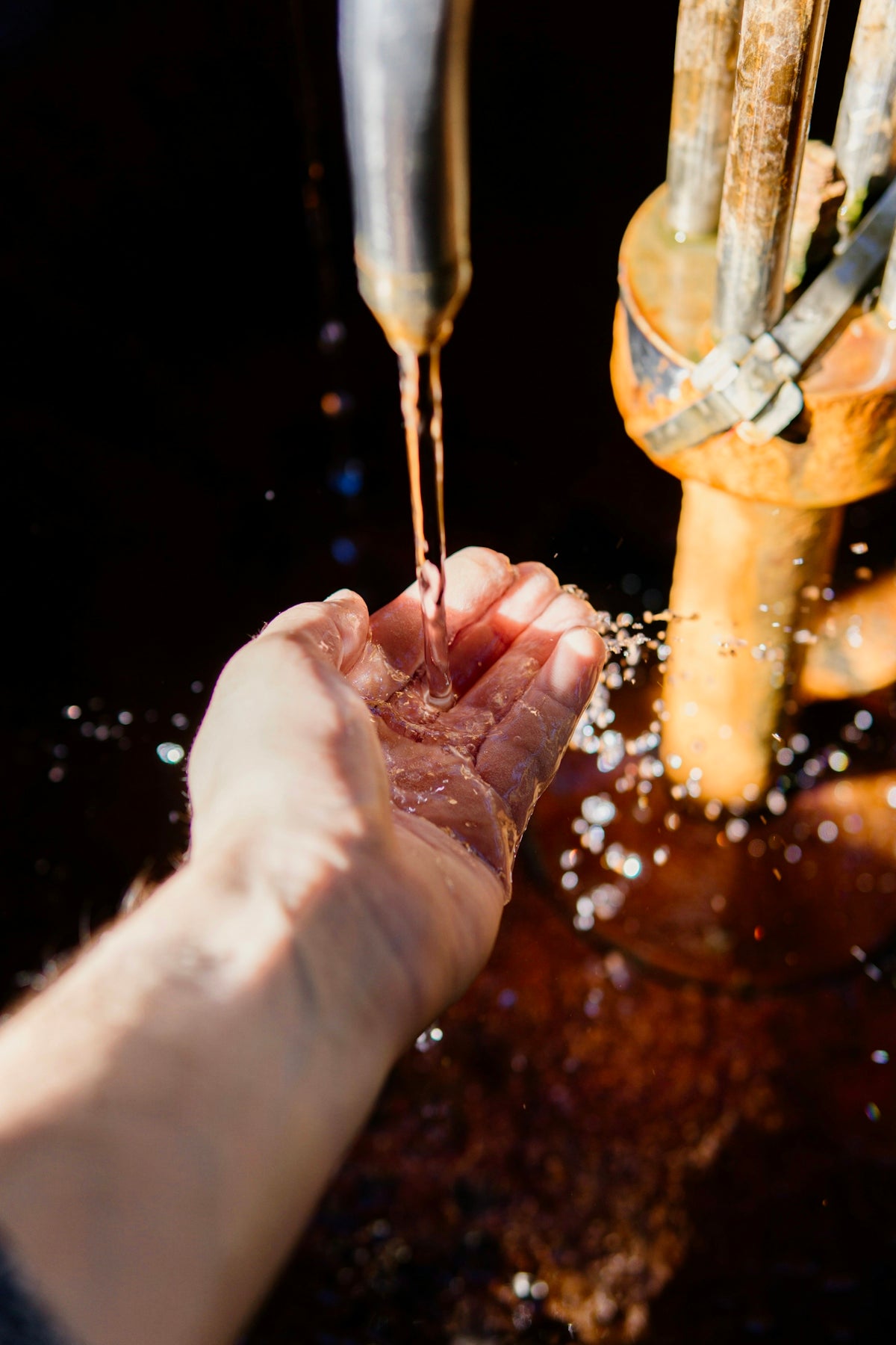 water dropping on person's left palm