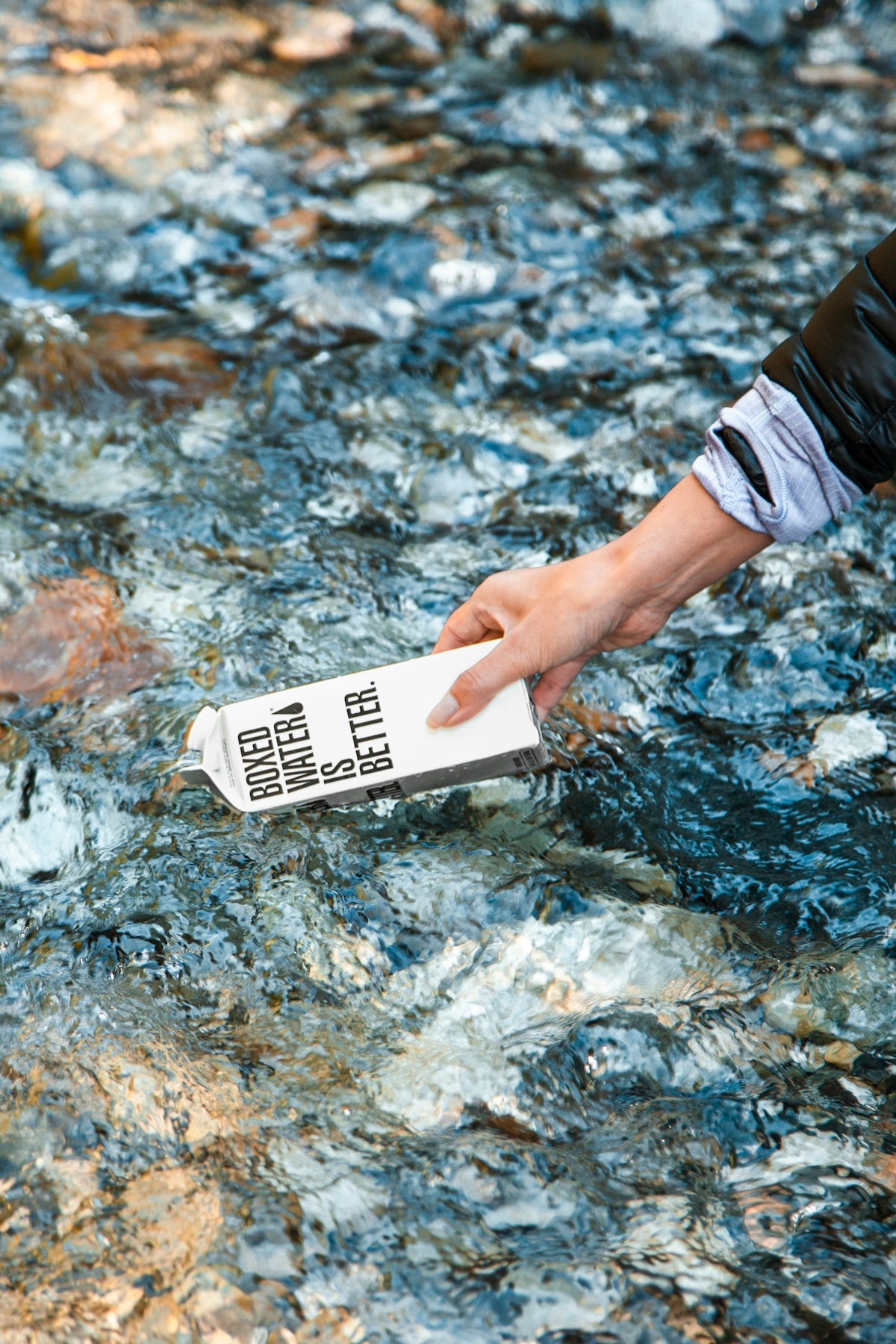 person holding white card on water